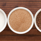 Three dishes on countertop: white sugar, light brown sugar, and dark brown sugar